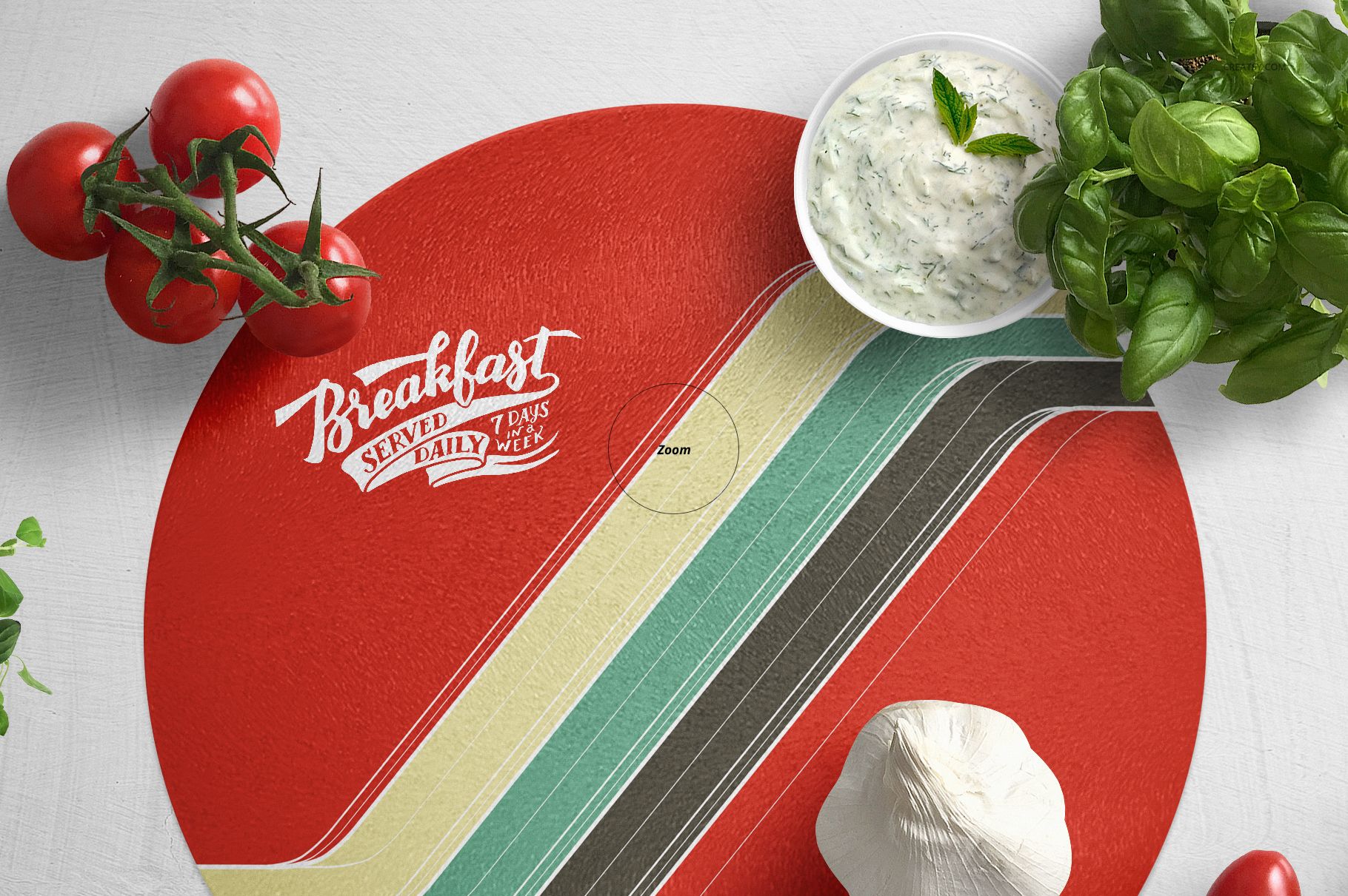 PSD mockup of a circular cutting board with bold graphic design, accompanied by basil leaves, garlic, and creamy sauce.