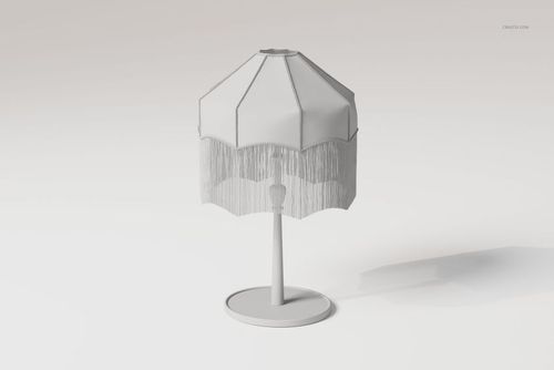 Front view of a tassel shade lamp with a polygonal white fabric shade and fringe detail on a round base, set against a light background.