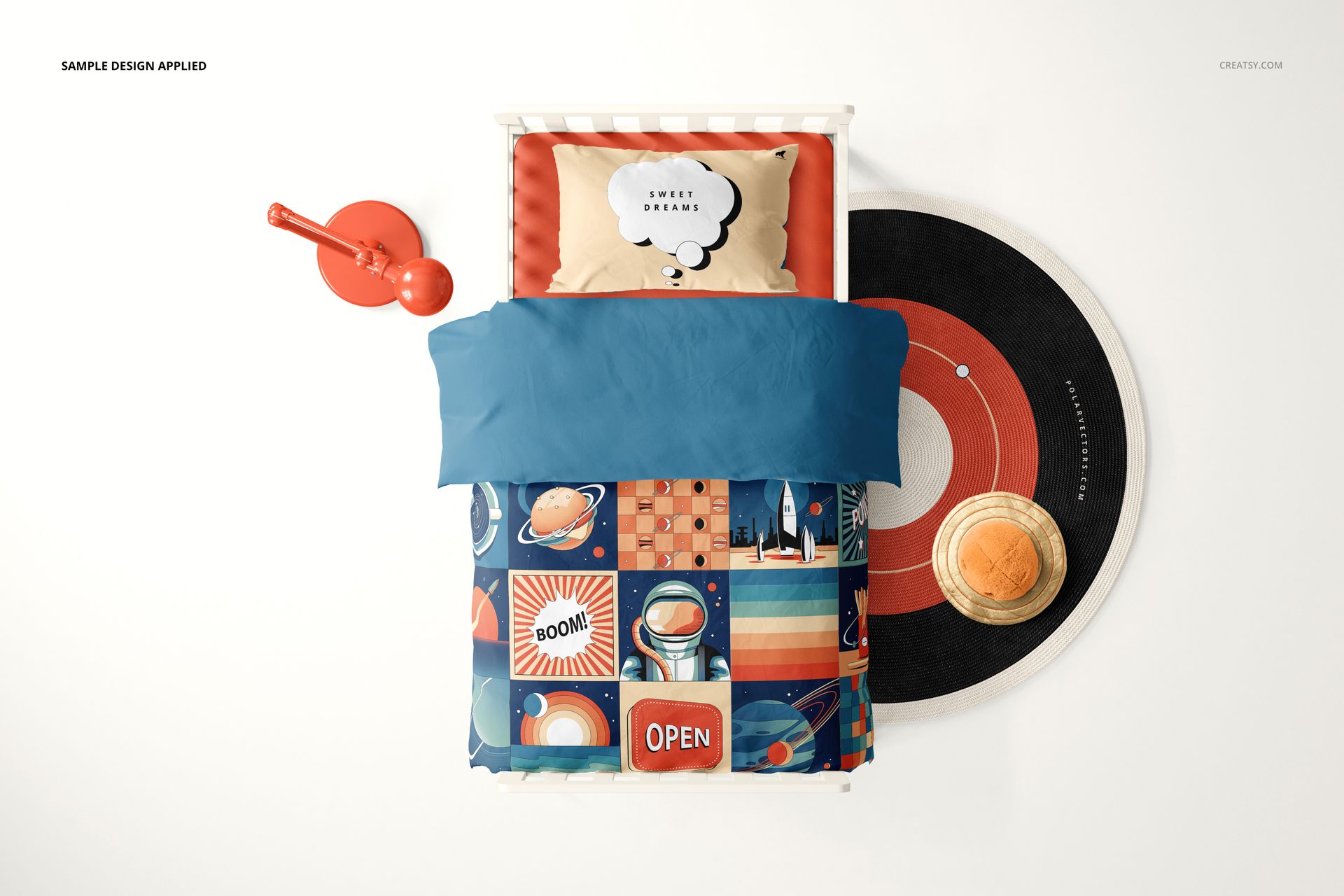 Top view of a toddler bedding mockup with colorful space-themed duvet, blue blanket, and matching decor in a kids room.