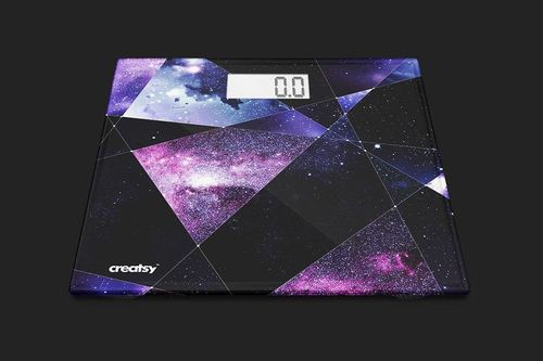 Top view of a digital weight scale mockup featuring angular shapes and a purple-blue cosmic design, screen reads 0.0.