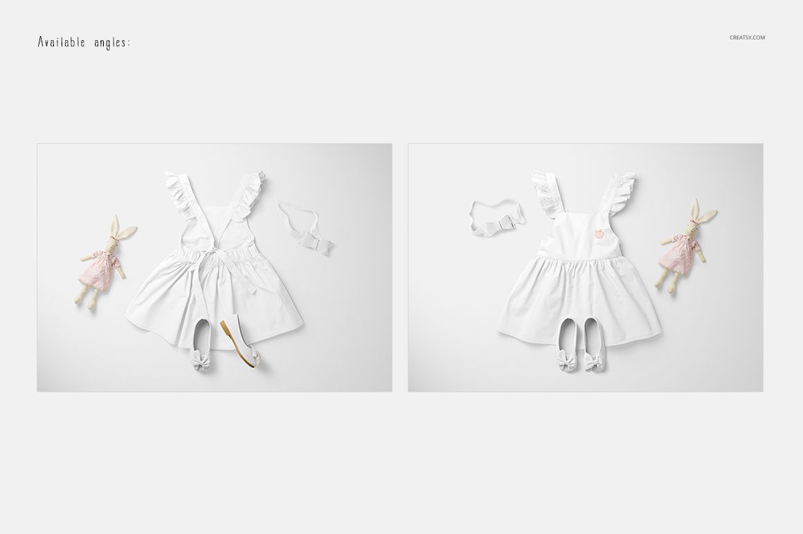 PSD mockup showing a white baby dress laid out with matching shoes, headband, and a doll, photographed from above.
