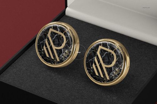Pair of gold cufflinks featuring a black marble texture and monogram, shown in a presentation box mockup.