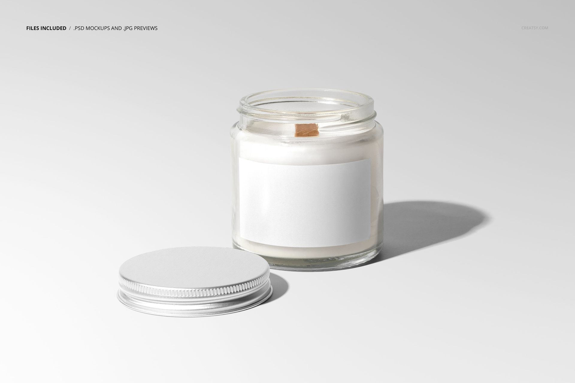PSD mockup of a scented candle in a transparent jar, featuring a plain white label and a silver lid nearby.