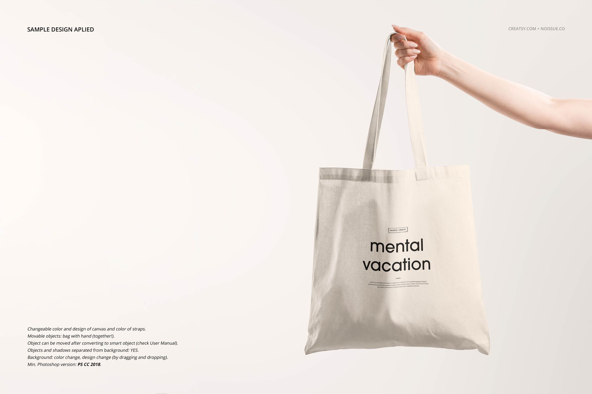 Minimalist beige tote bag mockup shown from the front, held by a hand, with plain black text and neutral backdrop.
