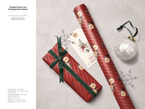 Top view of Christmas gift wrapping mockup with red floral wrapping paper, wrapped present, gift tag, and silver ornament.