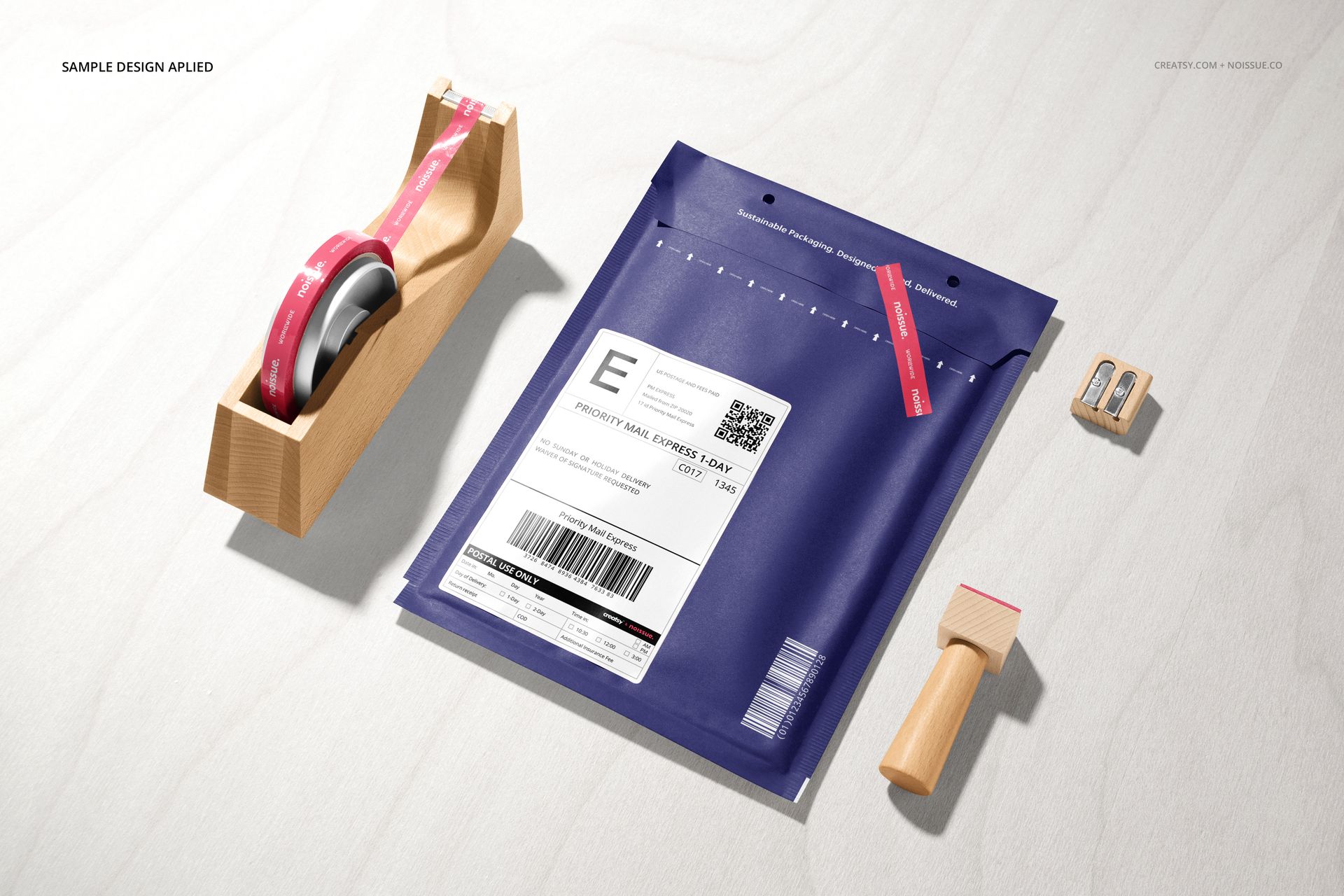 Shipping label mockup set featuring a blue envelope, tape roll in holder, wooden stamp, and double pencil sharpener.
