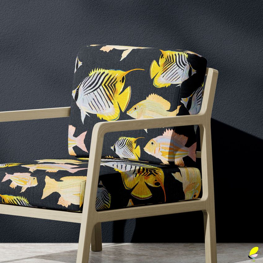 Lounge chair mockup with light wood frame and cushions featuring a colorful fish pattern on a dark background, set against a textured wall.