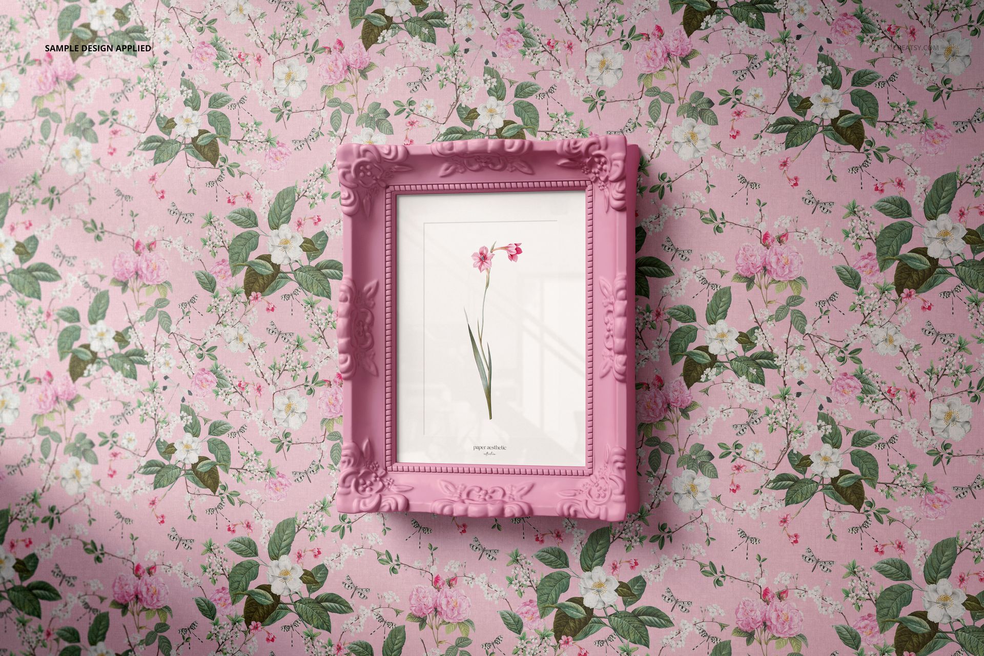 Front view of a classic painted picture frame mockup with ornate pink edges, displayed on floral wallpaper.