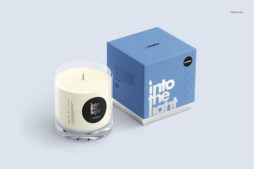 Ultimate Scented Candle mockup featuring a clear glass candle with white wax beside a blue packaging box, front view.