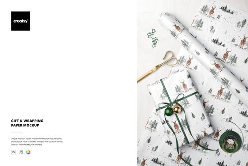 Christmas-themed PSD mockup featuring a wrapped present, holiday paper rolls, gold scissors, and green tree paper clips.