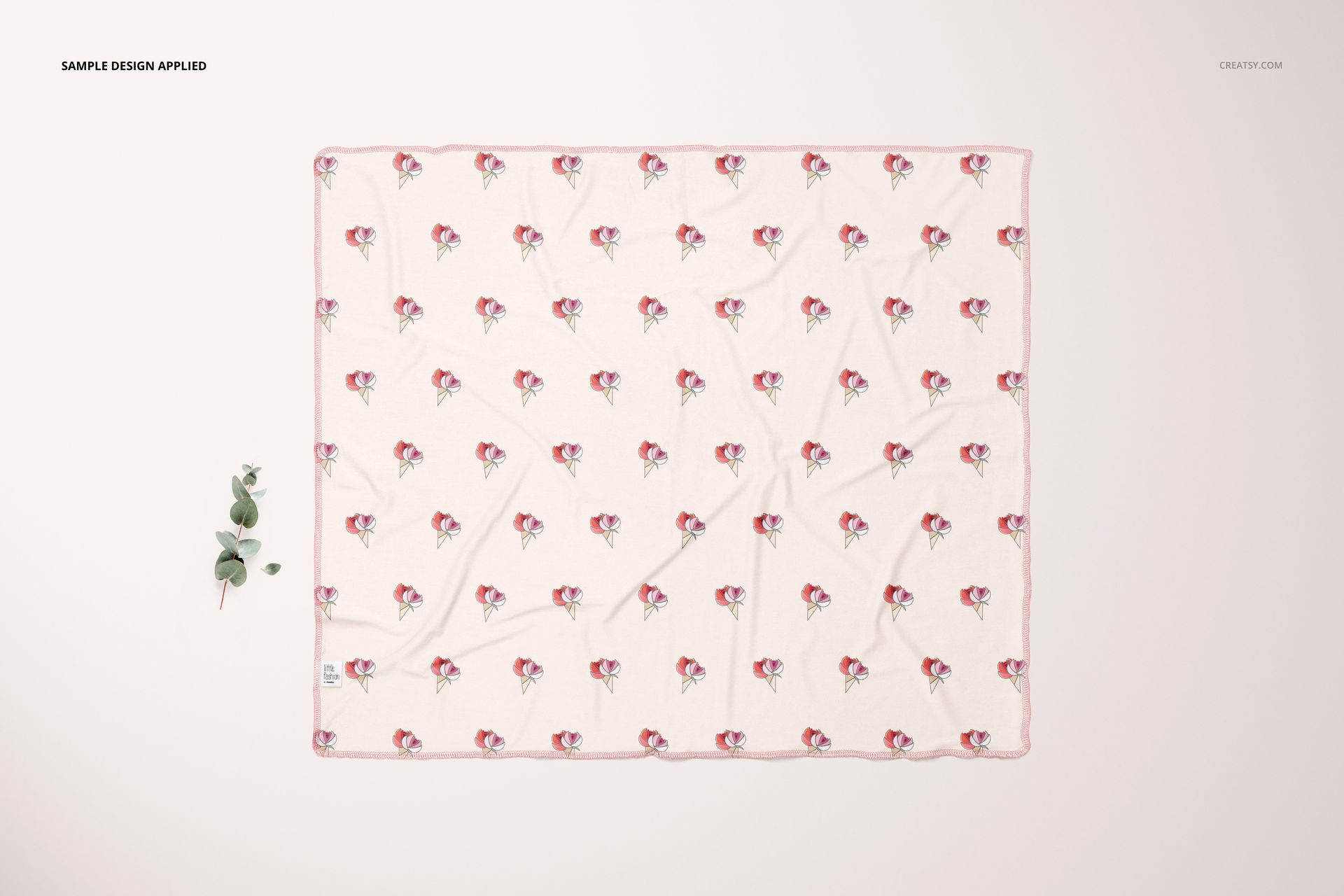 Rectangular swaddle blanket mockup featuring a delicate pink edge and scattered flower design, viewed from above.