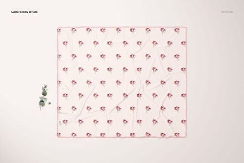 Rectangular swaddle blanket mockup featuring a delicate pink edge and scattered flower design, viewed from above.