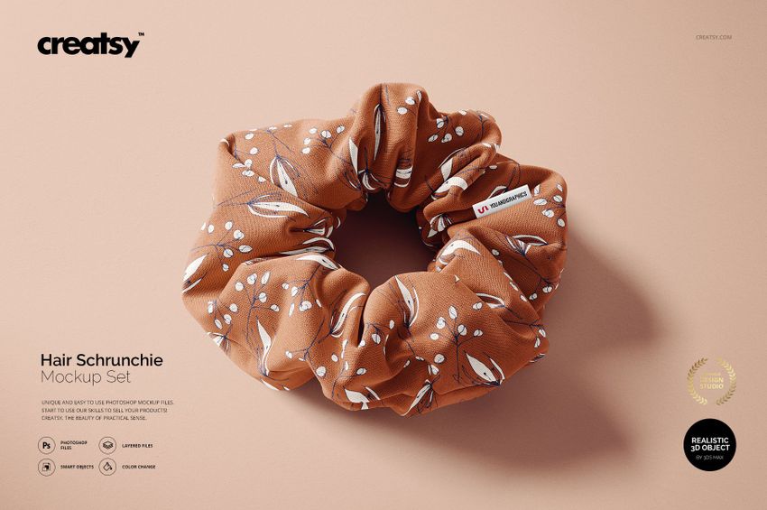 Single brown scrunchie featuring a botanical print, shown in a realistic PSD mockup on a neutral surface.