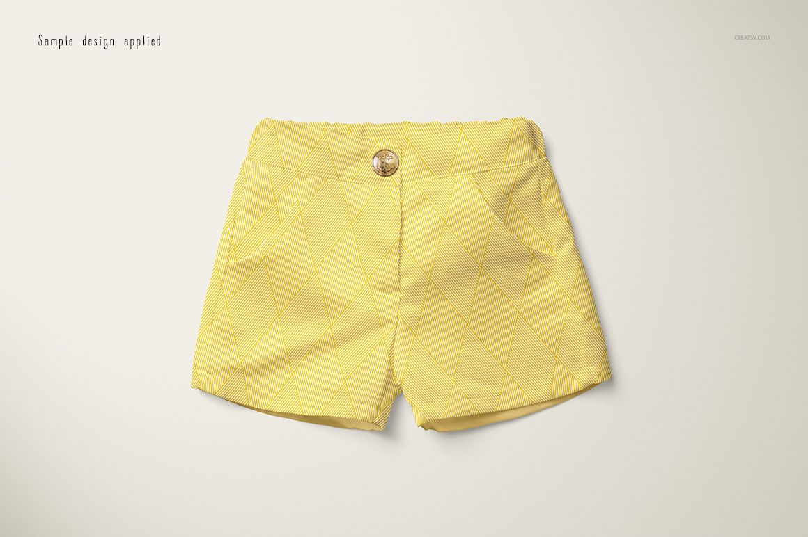 Front view of yellow baby shorts with a subtle diamond pattern, displayed on a light background in a mockup scene.