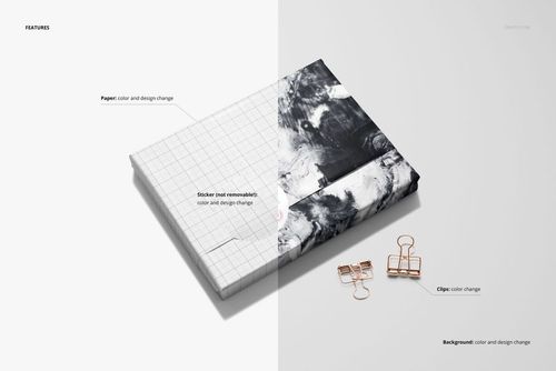 PSD mockup featuring a book in wrapping paper with grid lines and marble-like pattern, displayed with gold binder clips.