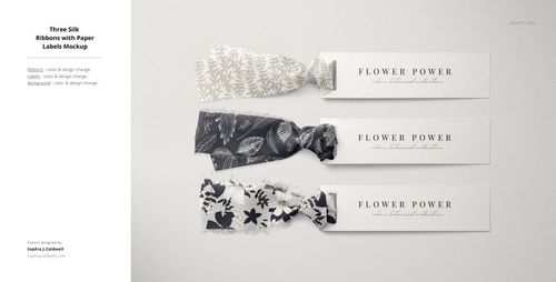 Mockup featuring three fabric pieces with botanical designs, each tied to a white rectangular label on a flat surface.