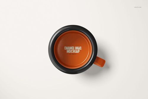 Top view of a small enamel mug with an orange interior and black rim, placed on a plain white surface.