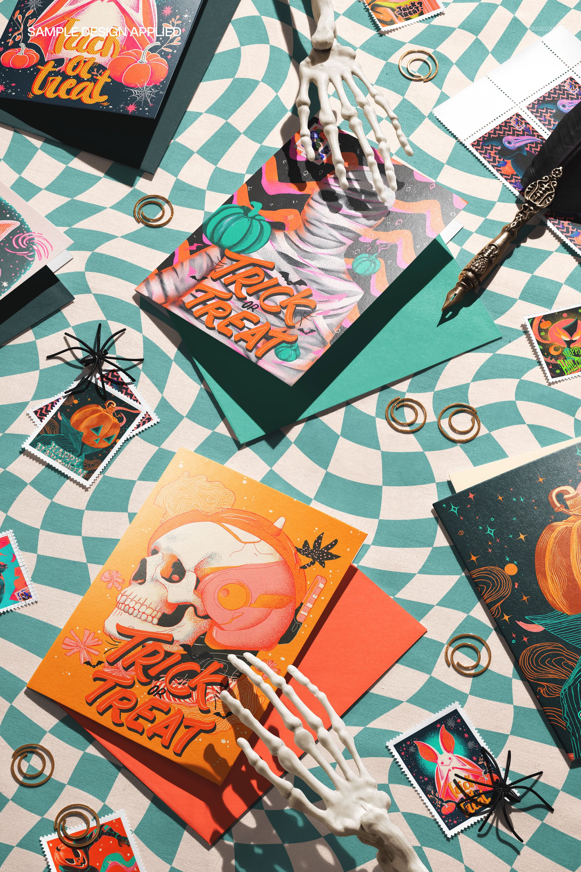 Halloween greeting card and envelope mockup with skeleton hands, colorful spiral background, and festive props.
