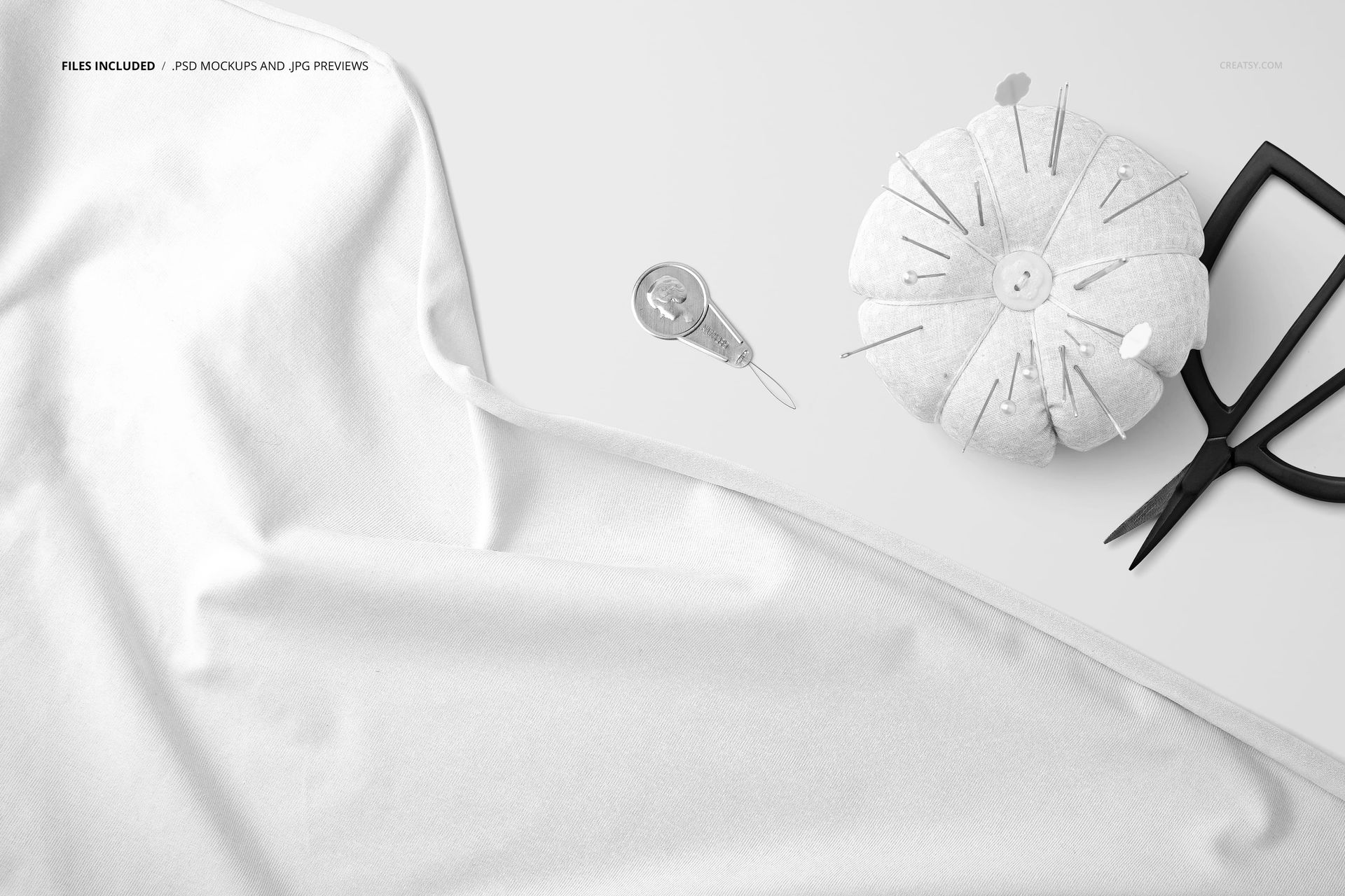 Jersey fabric mockup shown in a close-up, featuring a plain white textile and sewing accessories on a light background.