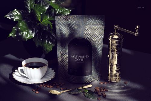 Front view of Azura Blend Coffee packaging mockup with dark botanical pattern, cup of coffee, grinder, and coffee beans.