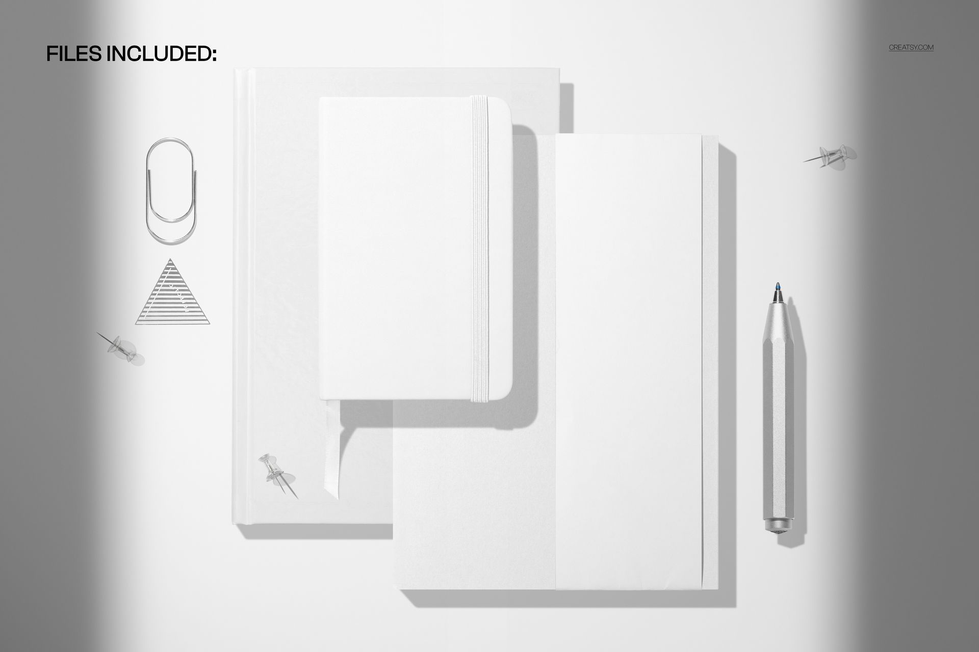 Top view of a pocket calendar hardcover notebook and planner mockup with white covers, pen, and paper clips on a light surface.