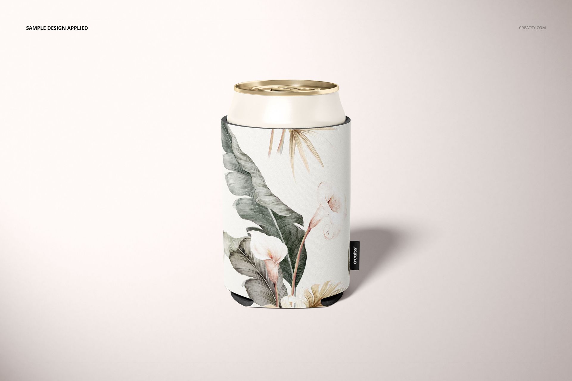 Neoprene can cooler mockup featuring a botanical design, shown upright with a gold-topped can on a neutral surface.