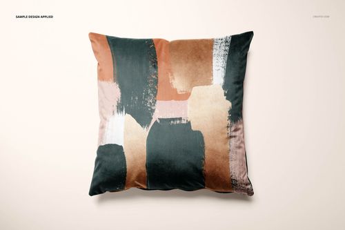 PSD mockup of a velvet cushion cover with a modern, multicolor abstract design on a light neutral background.