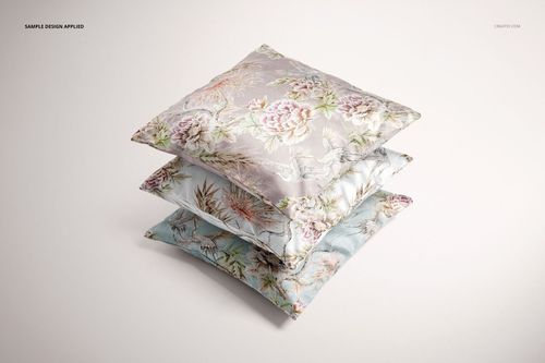 PSD mockup of polyester cushion covers with soft botanical prints, displayed in a stacked format against a plain backdrop.