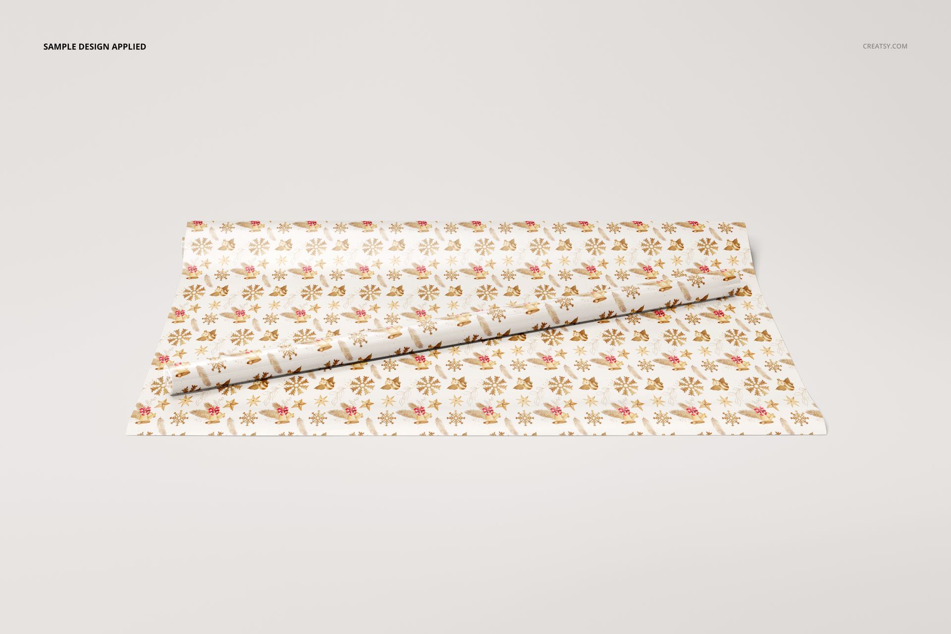 Rolled gift wrapping paper mockup featuring a repeating gold and red motif on a white surface, shown from above.