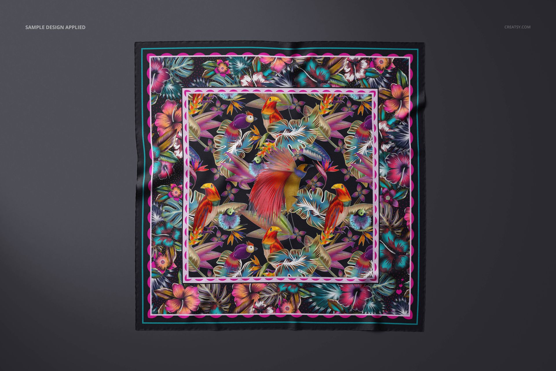Square cashmere scarf mockup featuring a colorful tropical bird and floral pattern, displayed flat on a dark surface.