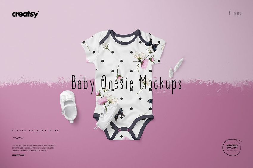 Front view of a baby onesie mockup with black trim, featuring a floral and butterfly pattern on a white background, set on a pink surface.