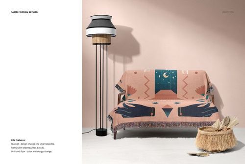 Mockup of a woven throw blanket with fringed edges and abstract design, displayed on a couch in a modern room.