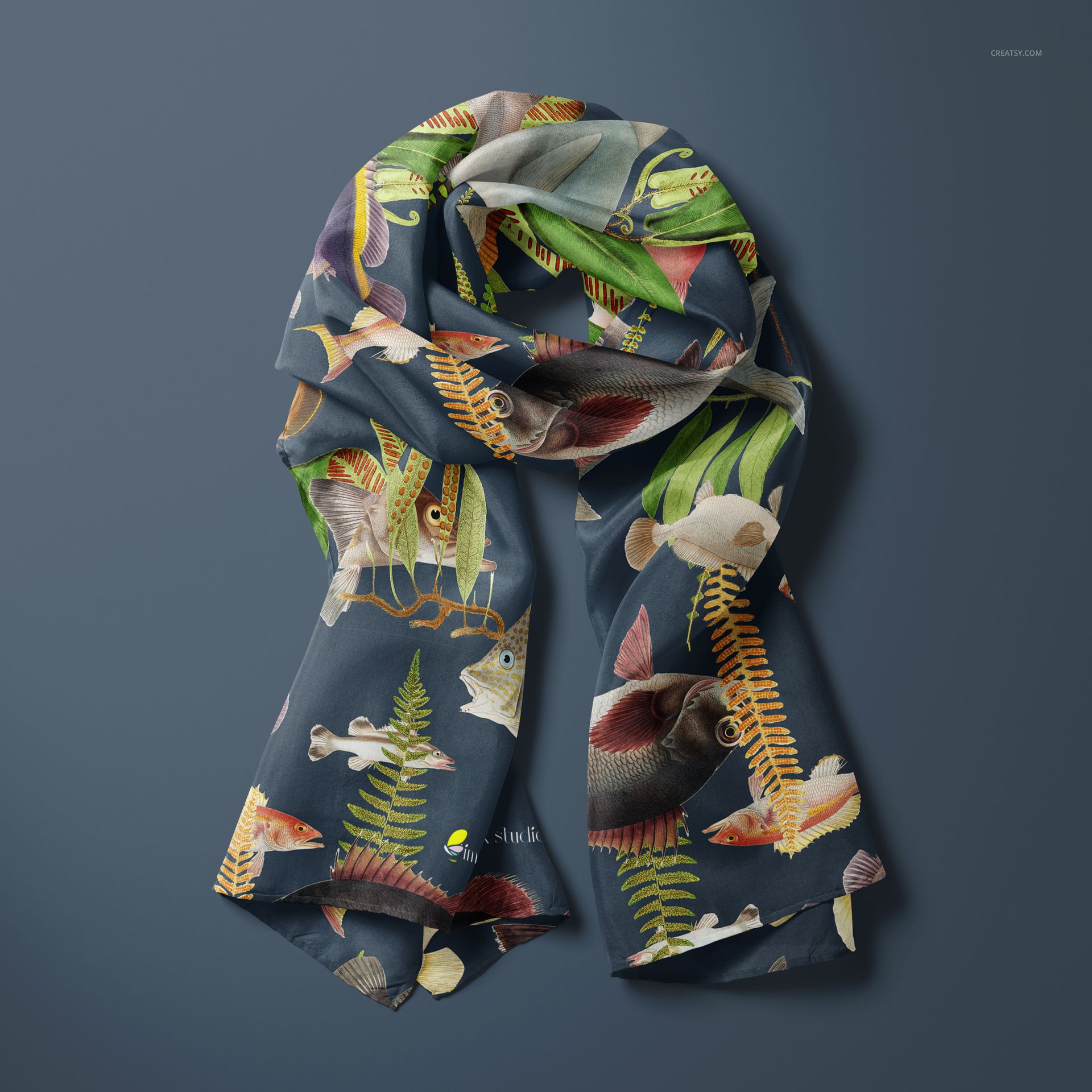 PSD mockup of a silk scarf featuring vibrant underwater fish and foliage, shown from a top view against a blue background.