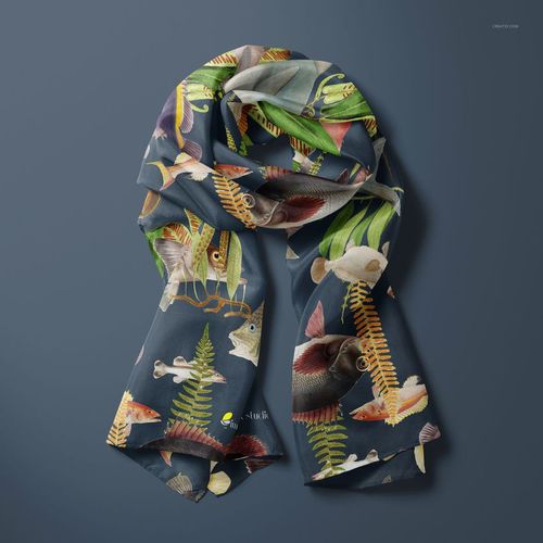 PSD mockup of a silk scarf featuring vibrant underwater fish and foliage, shown from a top view against a blue background.