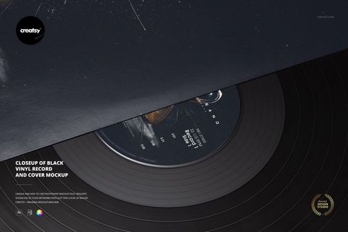 Detailed PSD mockup of a black vinyl record under a matching cover, viewed at an angle to show textures.