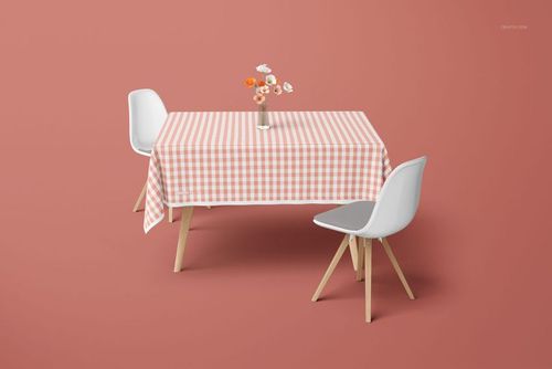 Tablecloth mockup showing a gingham pattern, wooden-legged chairs, and a simple vase of mixed flowers in a minimal scene.