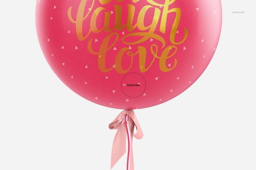 PSD mockup showing a spherical pink party balloon with gold calligraphy, geometric details, and a ribbon at the bottom.