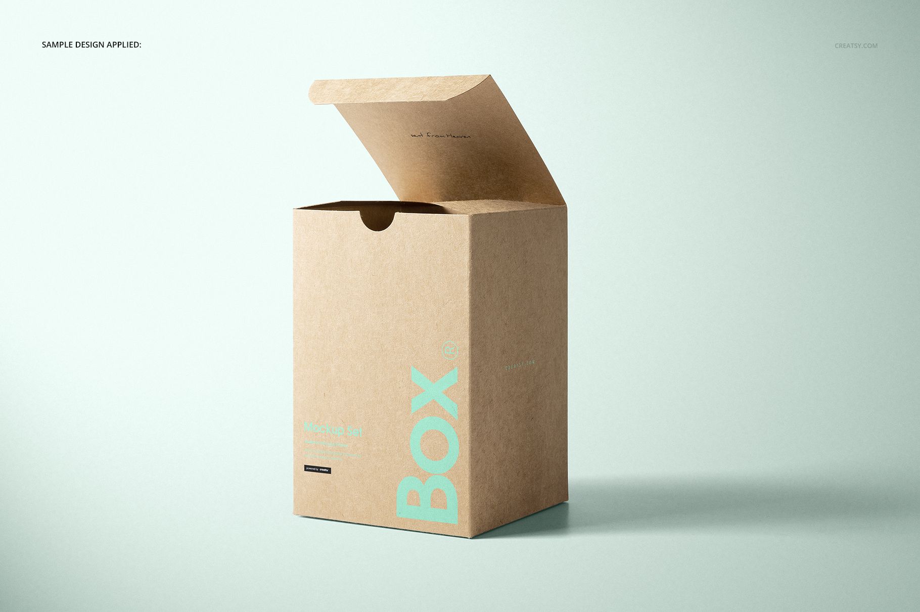 Kraft tuck top gift box mockup shown from the front, with open flap and minimal turquoise lettering on the box.