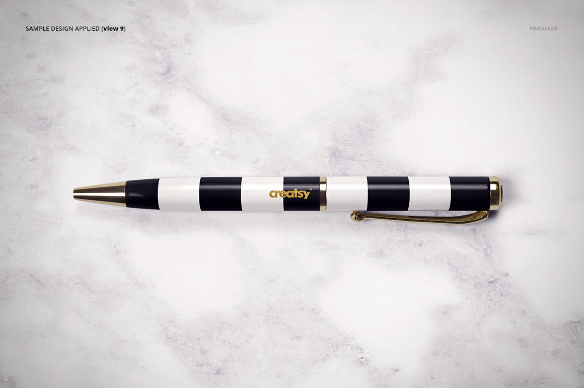 Front view of a striped pen with black, white, and gold colors resting on a pale marble tabletop, stationery mockup.