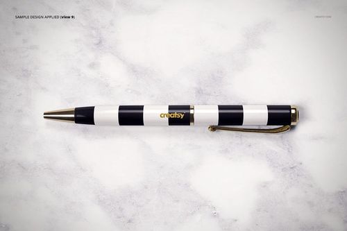 Front view of a striped pen with black, white, and gold colors resting on a pale marble tabletop, stationery mockup.