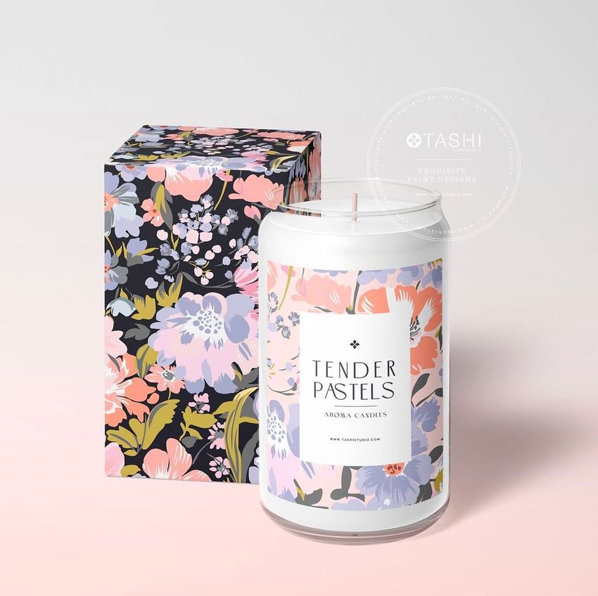 Can glass candle mockup featuring a white candle with a pastel floral label next to a matching decorative box on a light background.