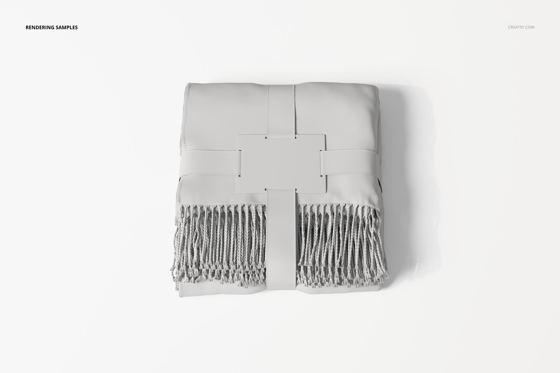 Folded fringe blanket in light gray color, viewed from above, with a rectangular label attached at the center.