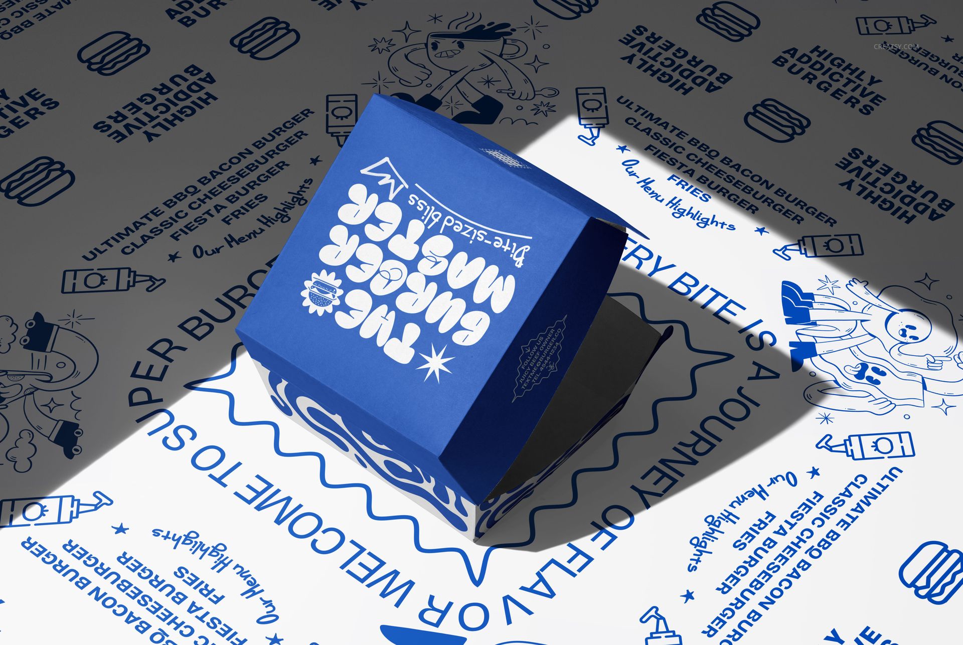 PSD mockup showing a blue burger box with bold white design elements, surrounded by themed food-related drawings.