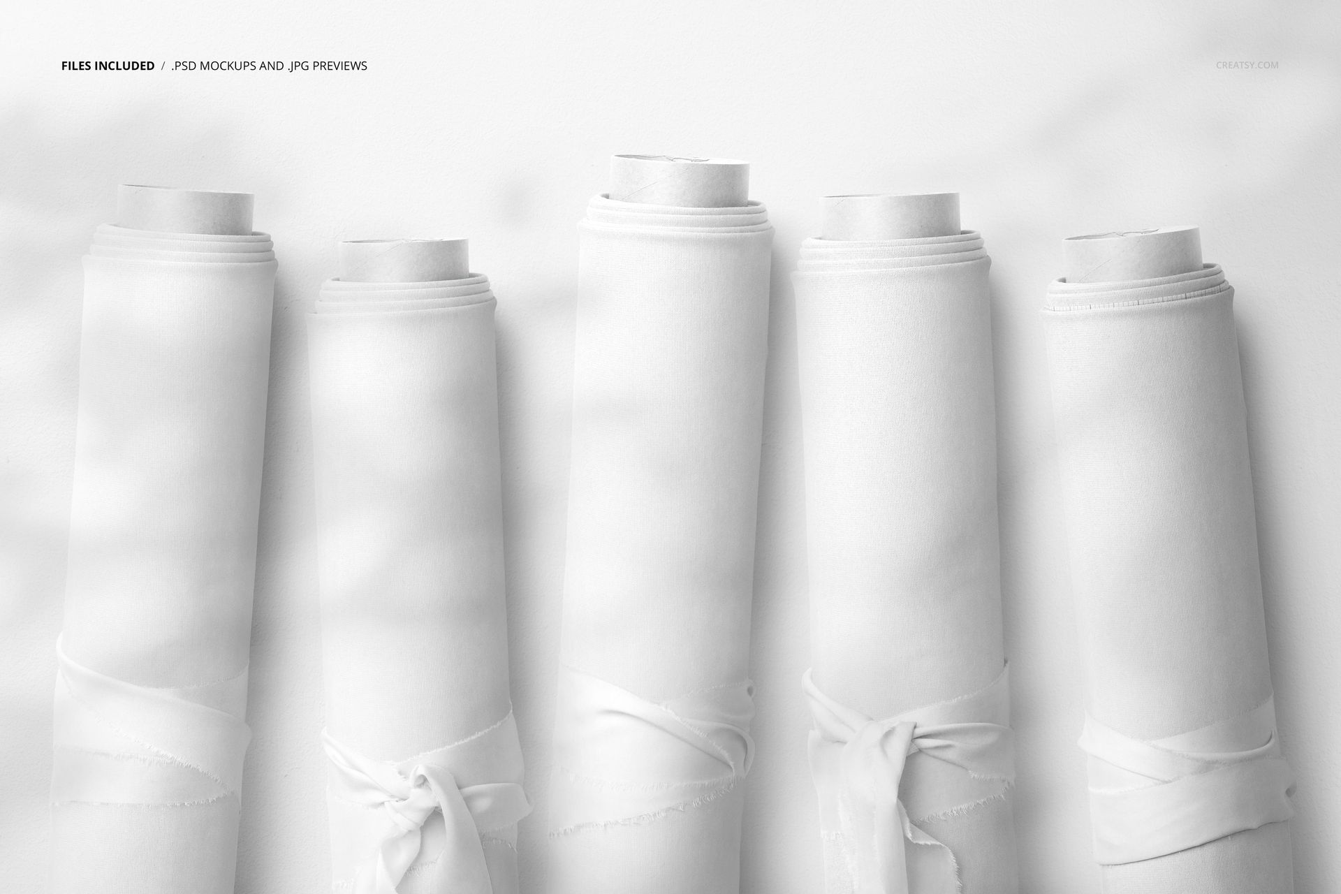Group of fabric rolls mockup showing five upright rolls with smooth white fabric against a light background.