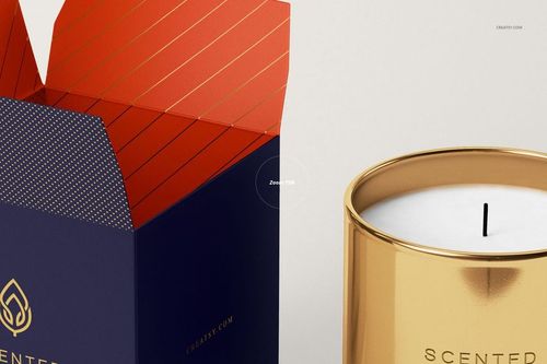 Front view of a gold metallic candle mockup and an open box with orange striped interior on a light background.