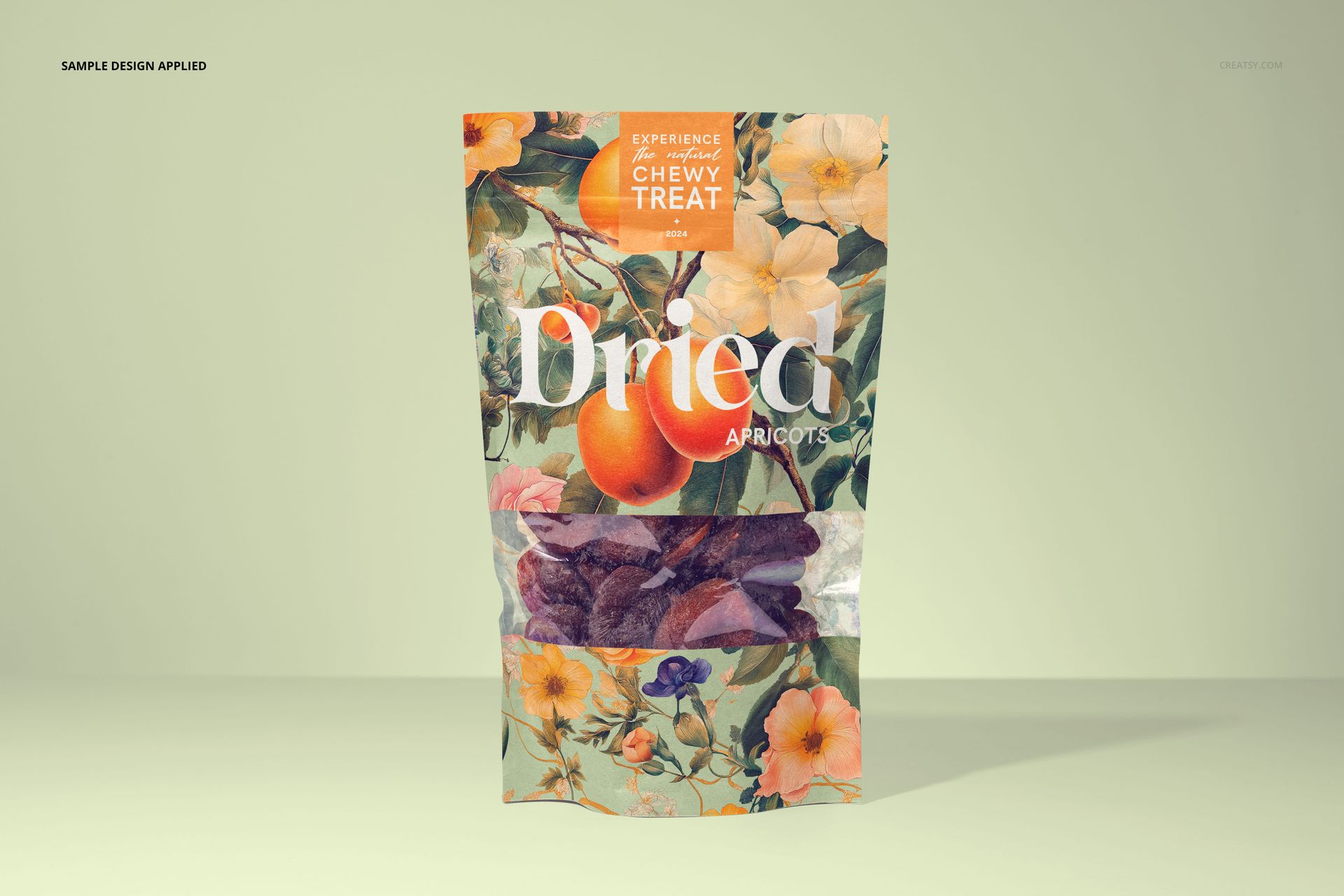 Front view of a paper pouch mockup for dried apricots, featuring a floral and fruit pattern on a light background.