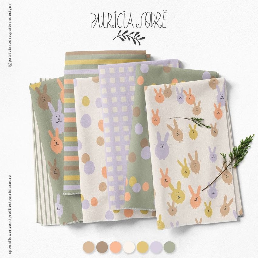 Folded fabrics mockup displaying pastel-colored textiles with bunny and polka dot patterns, arranged on a light surface.