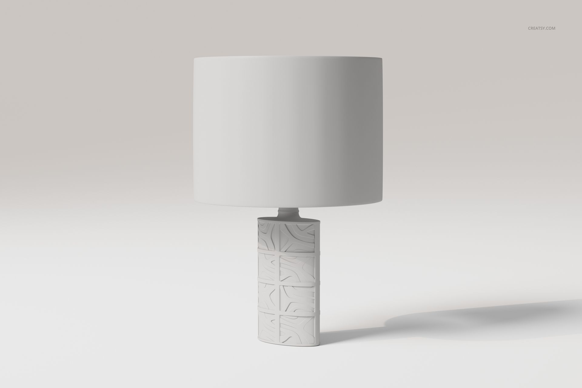 Decorative table lamp with a cylindrical base featuring geometric patterns and a plain white lampshade, front view.