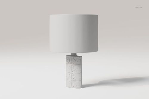 Decorative table lamp with a cylindrical base featuring geometric patterns and a plain white lampshade, front view.