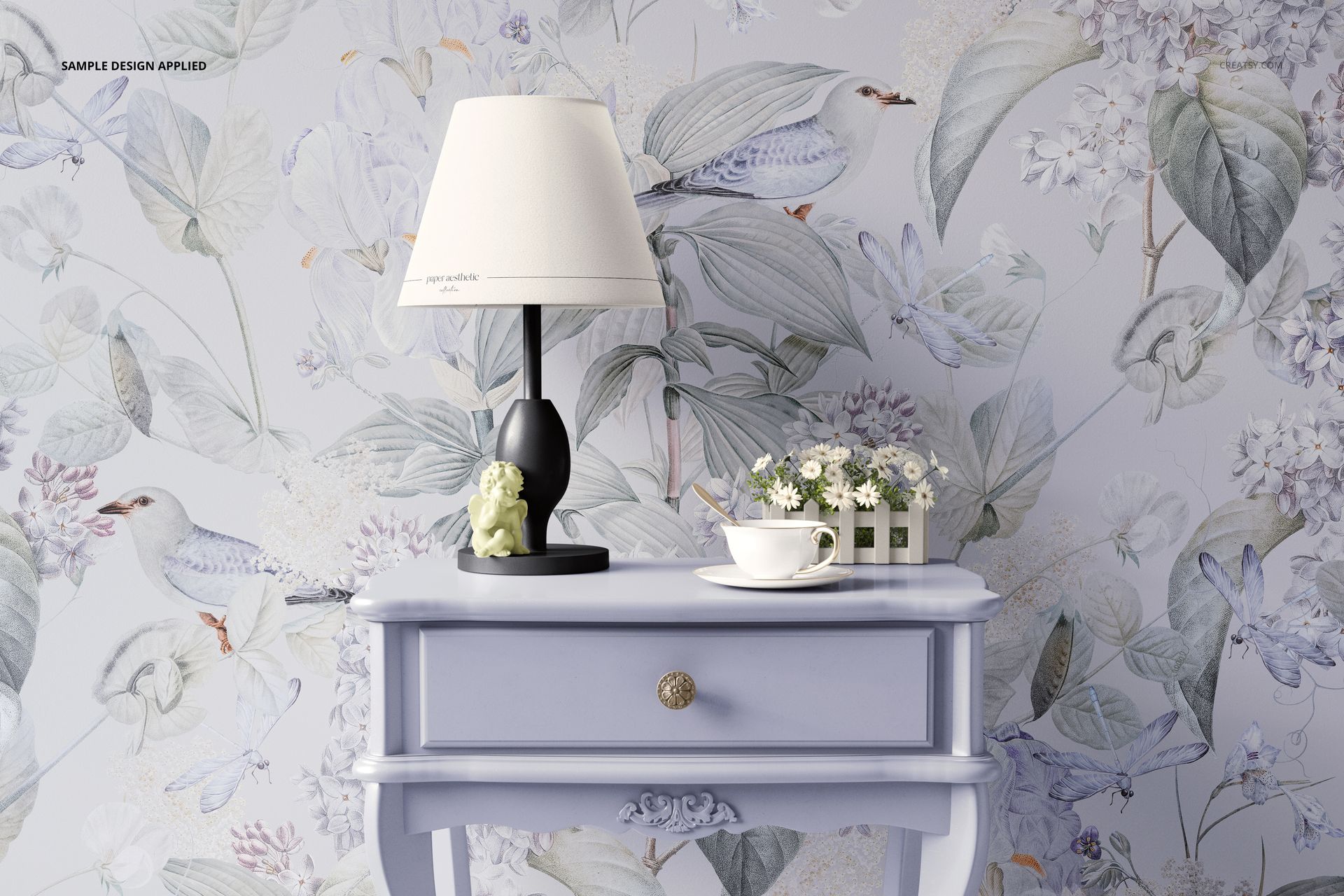 Classic console PSD mockup featuring a blue table, decorative lamp, and teacup, with a botanical wallpaper background.